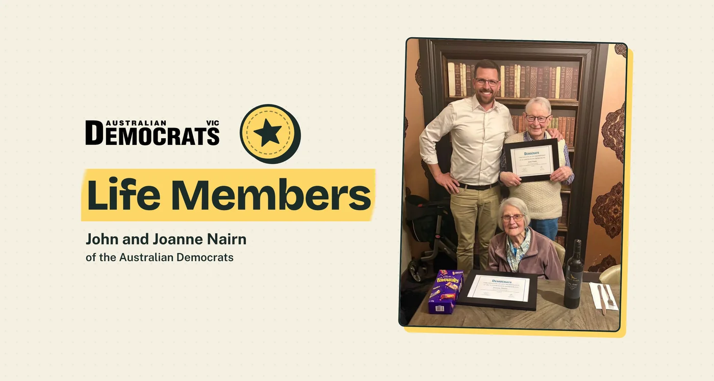 The Australian Democrats Victoria logo and a star stamp beside the words 'Life Members' on a yellow highlight and 'John and Joanne Nairn of the Australian Democrats', next to a framed photo of John and Joanne Nairn holding their Life Membership certificates